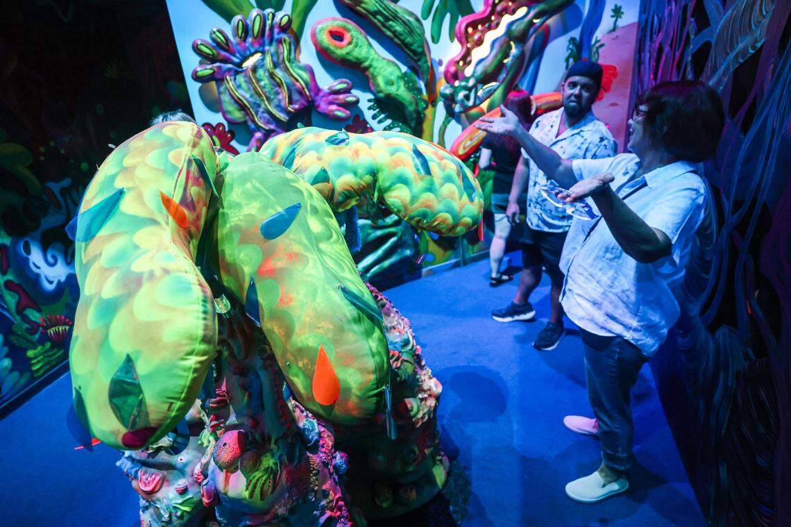 Exhibit attendees look at the “Technicolored Party Inside of My Head, But Everyone’s Invited” exhibit by Mariell Guzman at the Meow Wolf Grapevine ‘The Real Unreal’ at the Grapevine Mills Shopping Mall in Grapevine, Texas on Thursday, July 20, 2023.