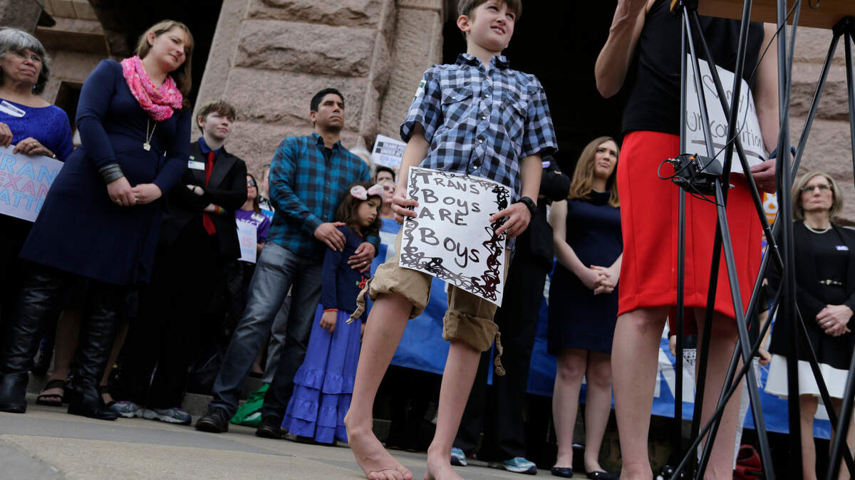 Max Briggle, right, joined other members of the transgender community during a rally on the steps of the Texas Capitol in March.