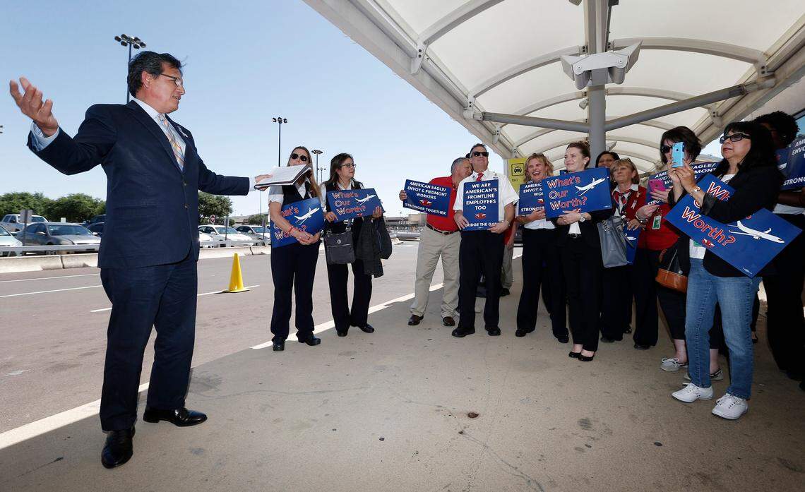 Texas Rep. Roberto Alonzo, left, lends his support to Envoy employees demonstrating for higher pay at DFW Airport’s Terminal B as contract negotiations being with management, Wednesday, April 27, 2016. Special/Brandon Wade