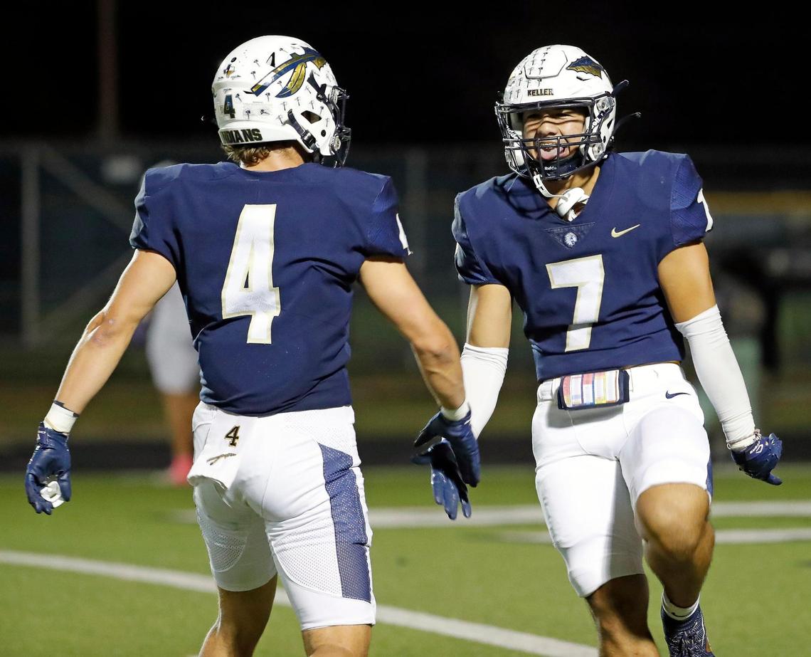 Keller defensive back Eli Brinton (4) congratulates Ryan Ventura (7) for his end zone interception in the second half of a District 4-6A high school football game at Keller ISD Stadium in Keller, Texas, Thursday, Oct. 27, 2022. Keller defeated Timber Creek 39-17. (Special to the Star-Telegram Bob Booth)
