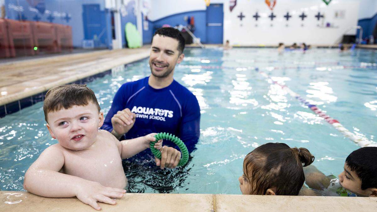 Johnathan Simmons, 3, takes swimming lessons with instructor Ryan Cleaver at Aqua-Tots Swim School on Thursday, May 21, 2026 in Fort Worth, Texas. Simmons has been swimming for about a year and a half.