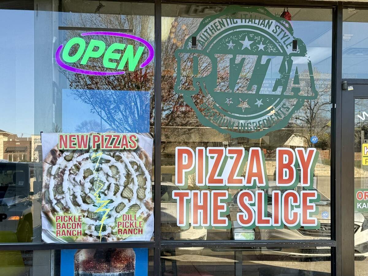 Kabylo’s Pizza by the Slice has an eye-catching sign for its dill pickle-ranch pizza in a North Richland Hills shopping center next door to a popular mochi doughnuts shop, as seen Jan. 11, 2026.
