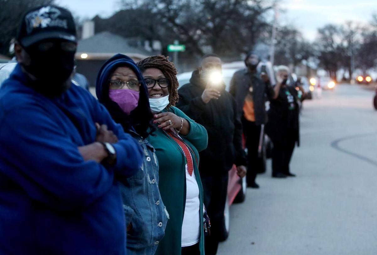 Friends and family line the street outside of Thomas Dixon’s home on Friday, December 18, 2020. A group of friends who grew up together on the south side of Fort Worth gathered to caravan past Dixon’s home to show their love and support since they could not visit him due to COVID-19 safety protocols. Dixon is currently receiving in-home hospice care for pancreatic cancer.