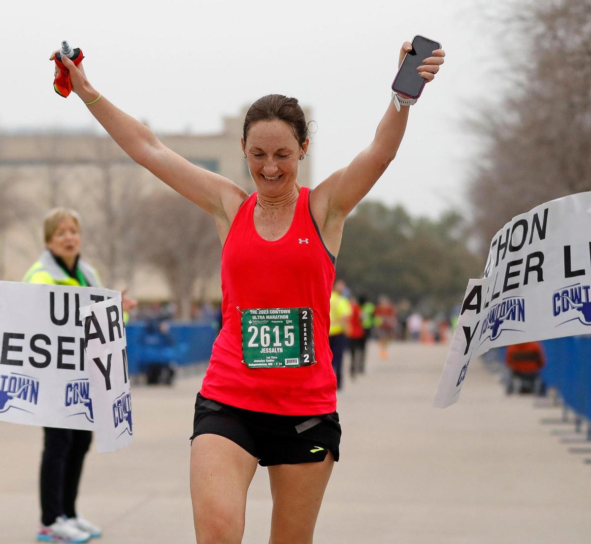Jessalyn Sadler celebrates winning the women’s ultra marathon with a time of 3:49.31 during the 2023 Cowtown Marathon in Fort Worth, Texas, Sunday, Feb. 26, 2023. Almost 21,000 runners registered for the two day event. (Special to the Star-Telegram Bob Booth)
