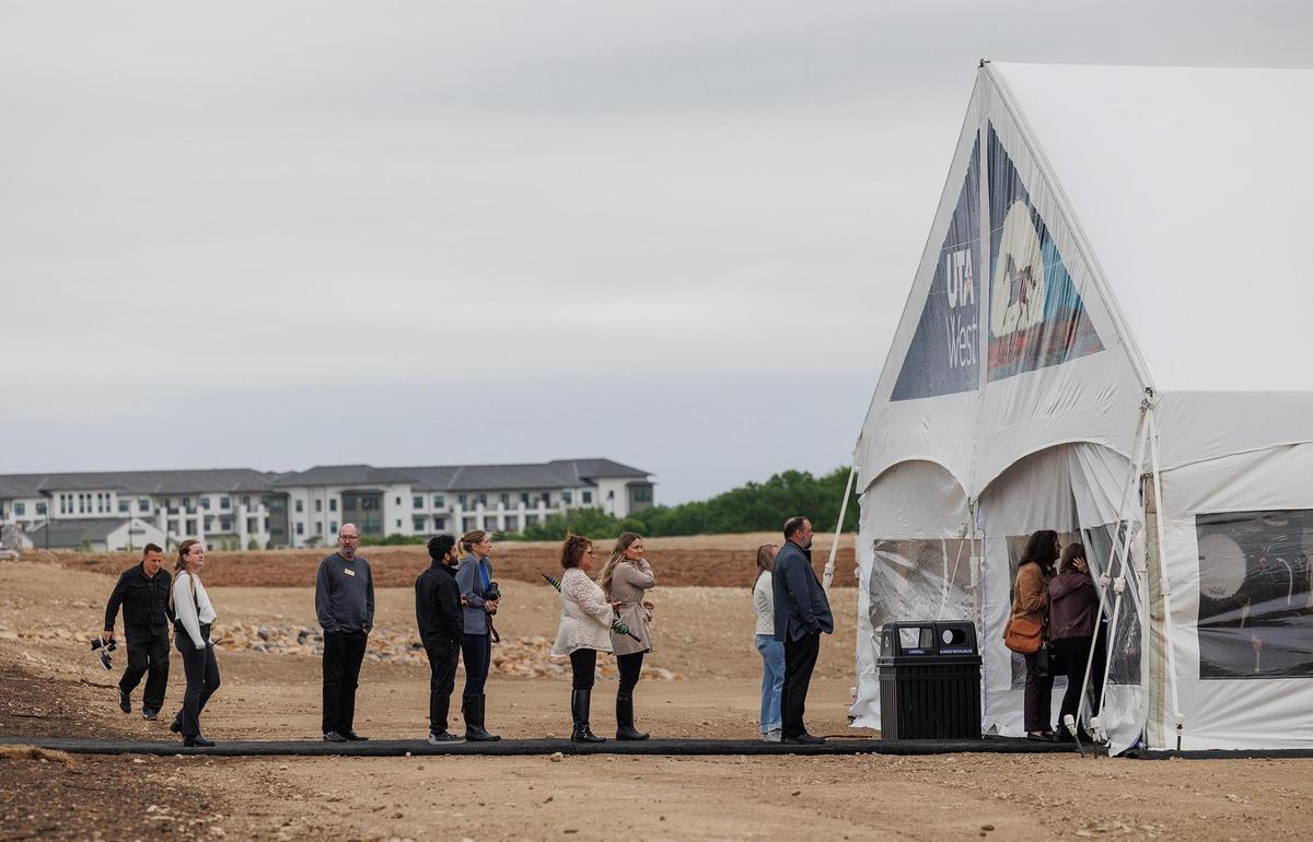 Guests enter a tent for the groundbreaking ceremony for the new UTA West campus on Thursday, April 3, 2025. The campus will cover around 51 acres just within the boundaries of Parker County and Fort Worth.