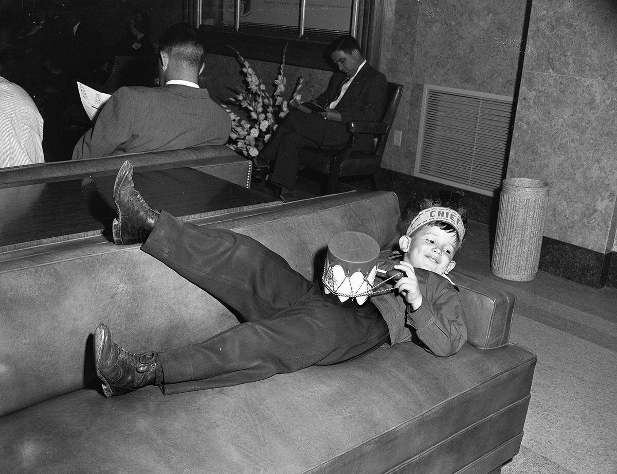 April 16, 1953: A boy is laying on a couch at an event before the opening of Greater Fort Worth International Airport.