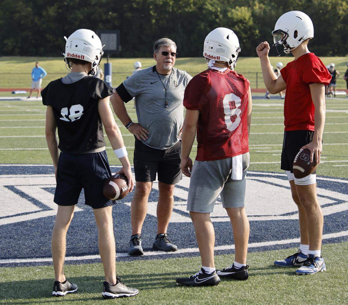 Head coach Aaron Beck talks with quarterbacks during the first practice of 2025 for the All Saints in Fort Worth, Texas, Tuesday August, 05, 2025.