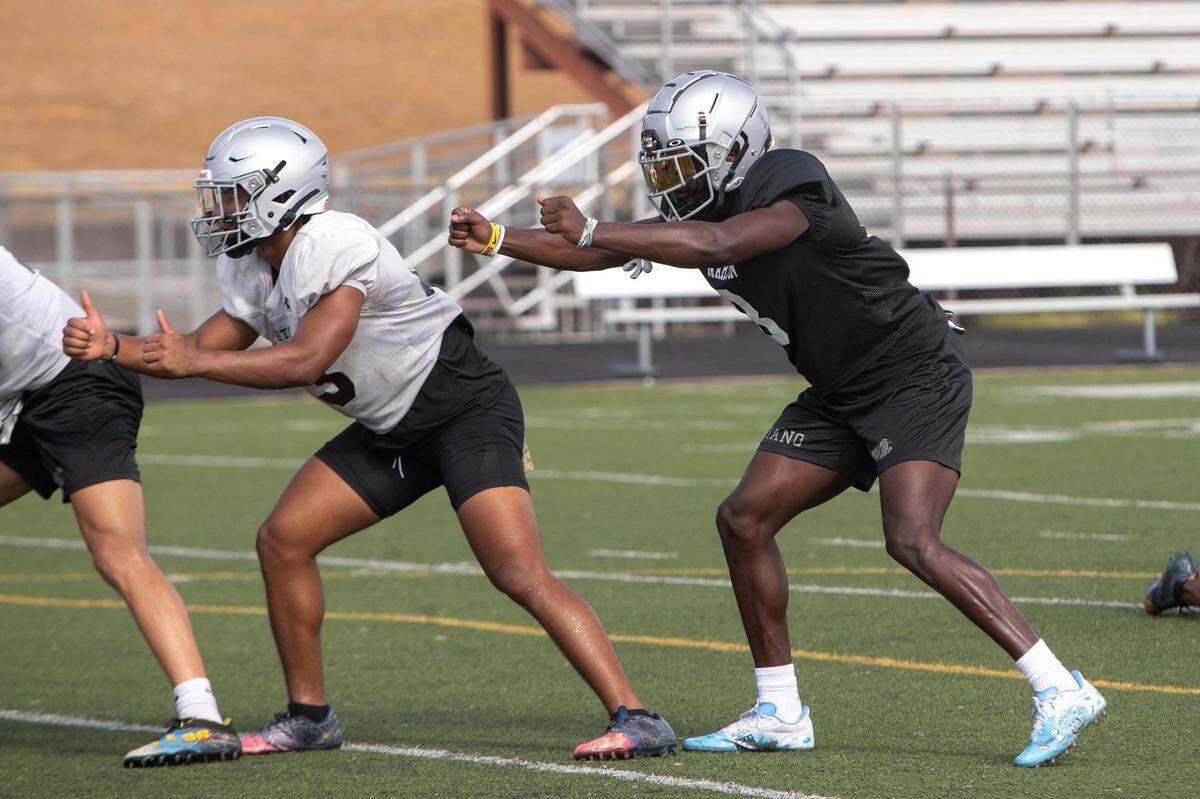 Cornernback Javien Toviano runs drills during football practice at Martin High.
