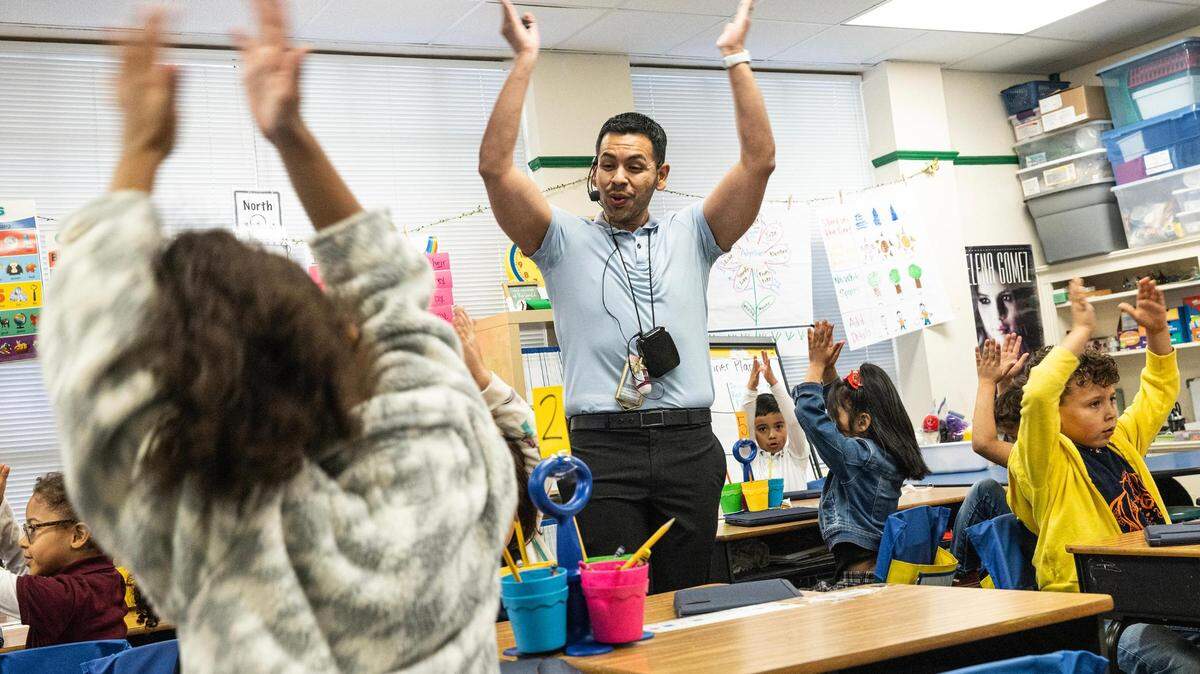First-grade teacher Luis Ortiz gets student participation for an activity to remember the vowels at South Hi Mount Elementary in Fort Worth on Tuesday, Dec. 5, 2023.