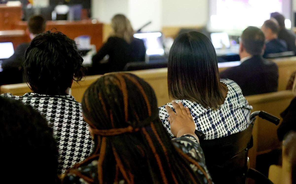 Family of Atatiana Jefferson, including sister Amber Carr, right, comfort each other while watching Aaron Dean’s bodycam footage from the night of October 12, 2019 during the second day of trial on Tuesday, December 6, 2022. Dean fatally shot Jefferson in 2019 during an open structure call.