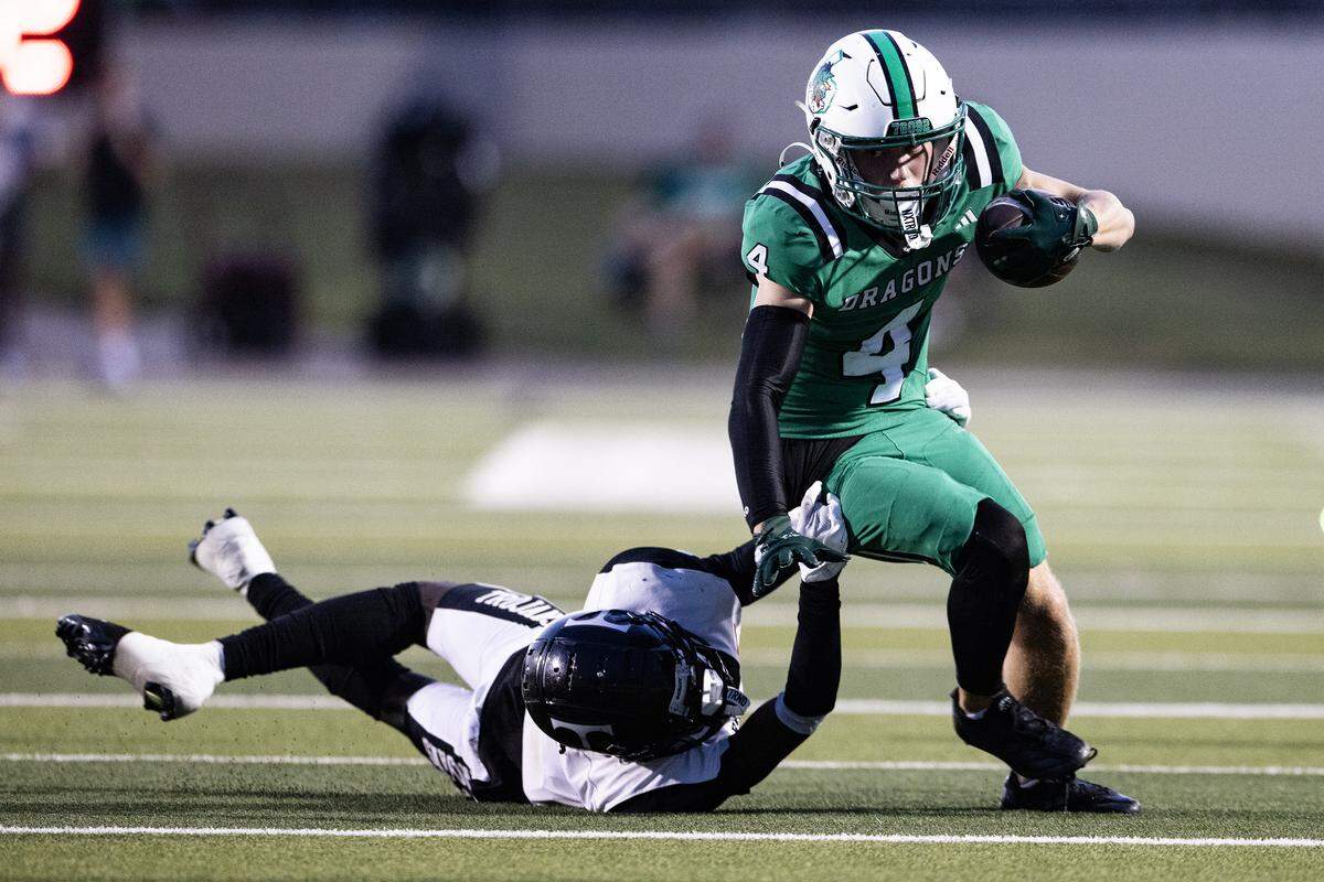 Eusless-Trinity defensive back Caleb Adom (8) jumps to tackle Southlake wide receiver Luc Jacquemard (4) in the first half of an high school game between Southlake Carroll and Euless-Trinity at Dragon Stadium in Southlake on Friday, Sept. 19, 2025.