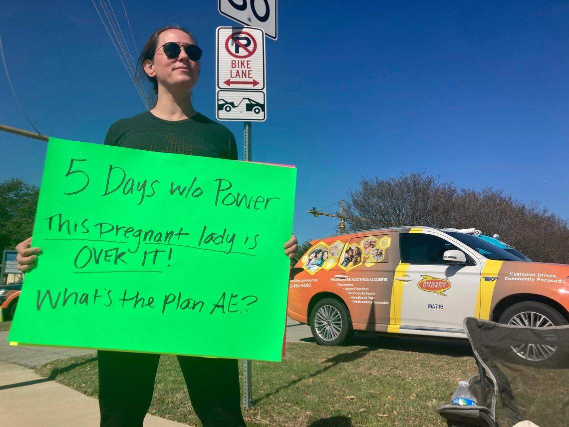 Katy Maganella, 37, protests in front of an Austin Energy truck in her neighborhood in Austin, Texas, Sunday, Feb. 5, 2023. Thousands of Austin residents remained without power days after an ice storm knocked out electricity to nearly a third of the city’s customers. (AP Photo/Paul Weber)