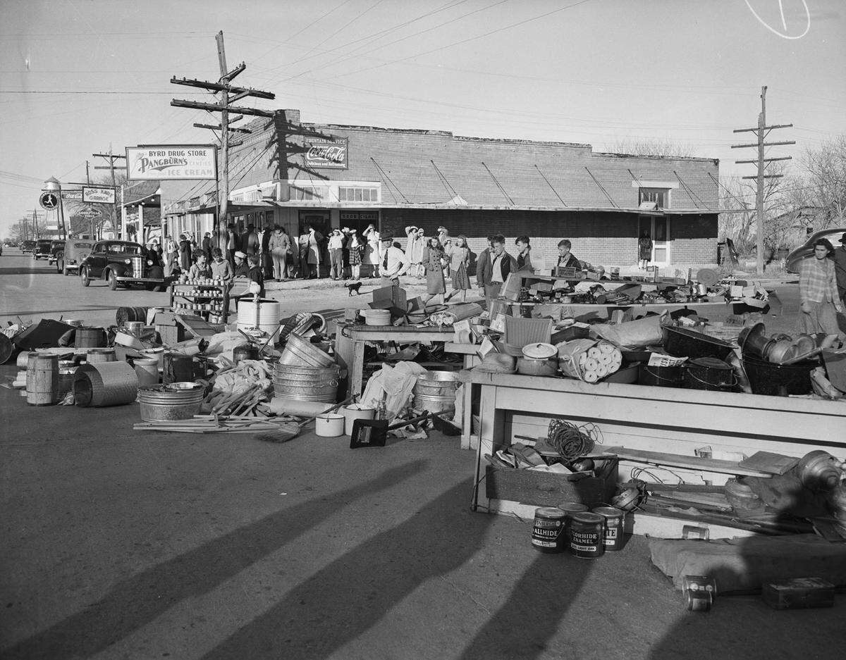 Dec. 5, 1941: Residents of Keller turned firefighters when a grass fire started a blaze that destroyed a lumber yard, beauty shop and hardware store. While they waited for a water hose to be brought from Roanoke, Texas, seven miles away, the volunteer firemen removed merchandise from the hardware store. Behind them is a line of people at Byrd Drug Store.