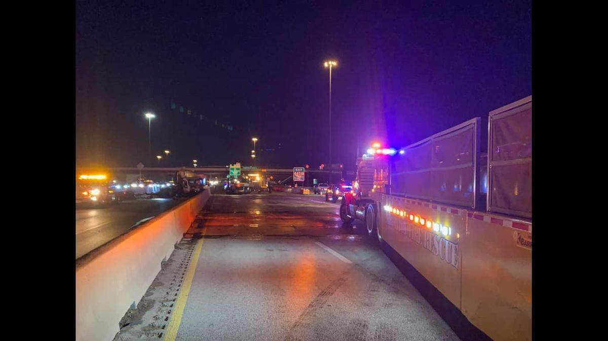A fire truck blocking traffic on a freeway.