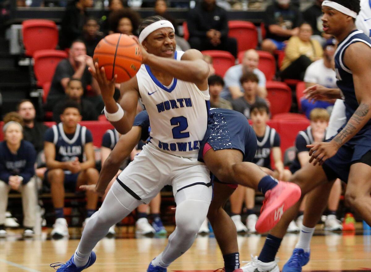 North Crowley’s Kameron Price has Allen’s Nehemiah Lawrence on his back as Price tries to pass during their Class 6A 1D Regional Semi Final game on Tuesday night at Coppell High School.