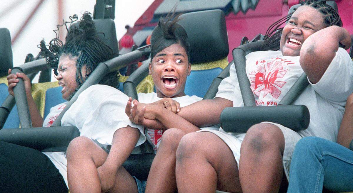 Sept. 25, 1999: Tiffany Clay, left, Rosane Upshaw and Varencia Williams hold on in shear terror as they ride the Avalanche ride on the opening weekend day at the State Fair of Texas in Dallas.