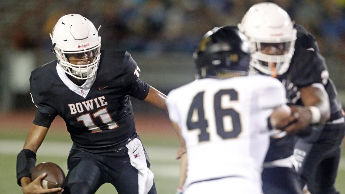 Bowie quarterback Malcolm Mays (11) gains yardage on a quarterback keeper as Mansfield played Bowie in a high school football game at Wilemon Stadium Friday September 07, 2018. The game was rain-delayed by over 45 minutes.