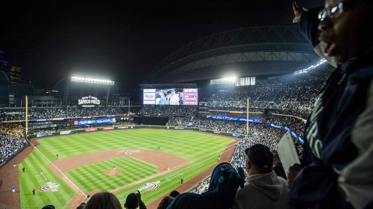 A sell-out crowd sings "Take Me Out to the Ball Game" during the seventh-inning stretch of a Mariners' game against the Indians on March 28 at Safeco Field in Seattle.