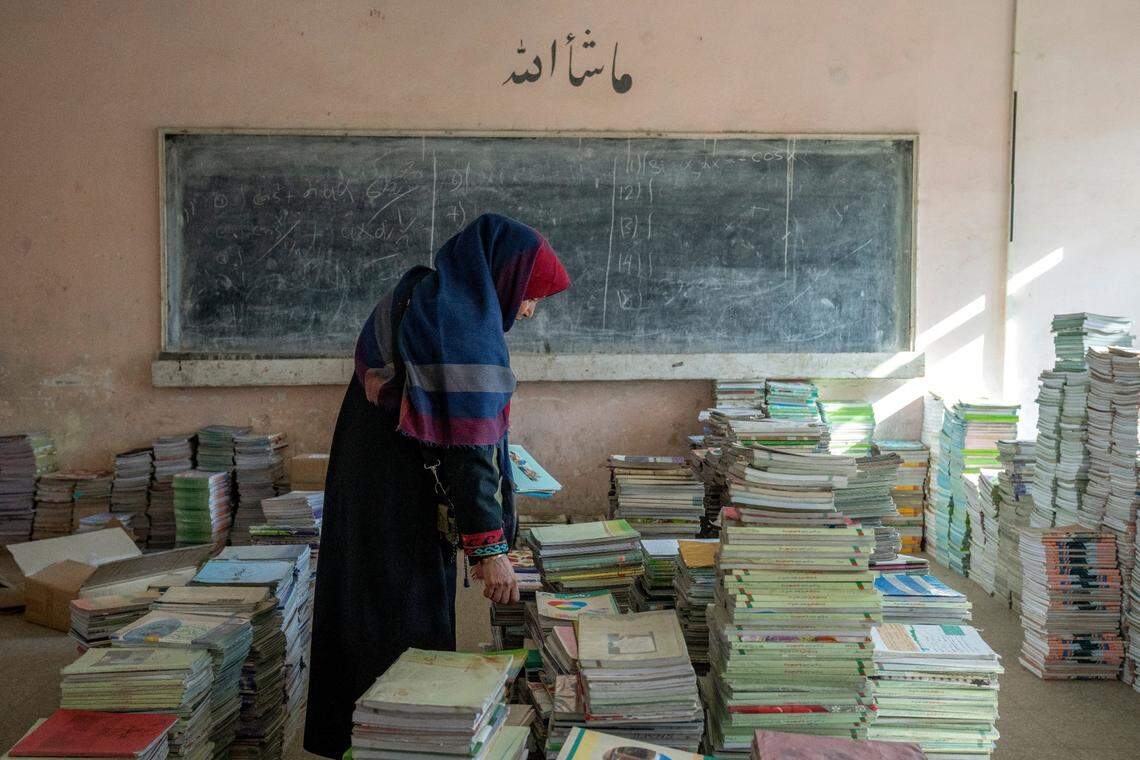 Amanah Nashenas, 45-year-old an Afghan teacher, collects books in a school in Kabul, Afghanistan, Thursday, Dec. 22, 2022. The country’s Taliban rulers earlier this week ordered women nationwide to stop attending private and public universities effective immediately and until further notice. They have banned girls from middle school and high school, barred women from most fields of employment and ordered them to wear head-to-toe clothing in public. Women are also banned from parks and gyms.&nbsp;(AP Photo/Ebrahim Noroozi)