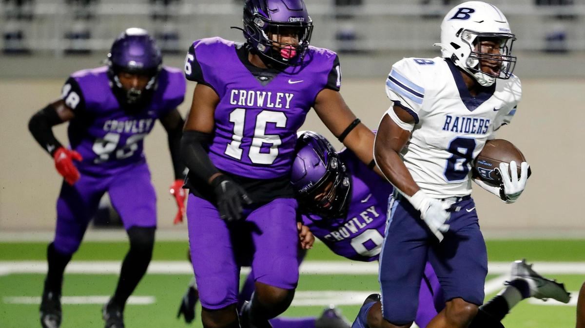 L.D. Bell running back Gracien Anto (8) attempts to get out of the backfield chased by Crowley defensive lineman Johnnie Wilson (16) in the first half of a high school football game at Crowley ISD Multipurpose Stadium in Crowley Texas, Friday, Sept. 23, 2022. L.D. Bell led Crowley 14-10 at the half. (Special to the Star-Telegram Bob Booth)