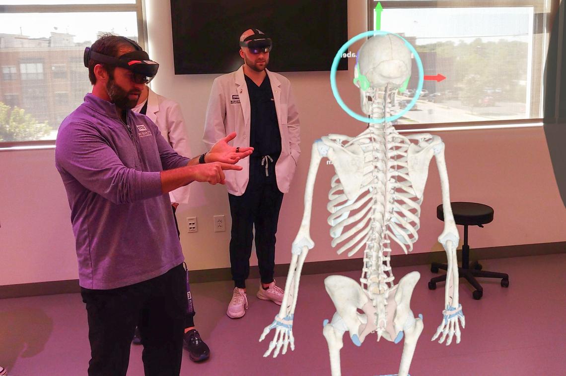 Adam Jennings, the Executive Director for Simulation, Innovation, and Research, explains to first year medical students Mason Runkel and Stephen Pullman the anatomy of the human body using their Microsoft Hololens for their HoloAnatomy demonstration used for classes at the TCU Burnett School of Medicine in Fort Worth on Tuesday, Sept. 17, 2024.