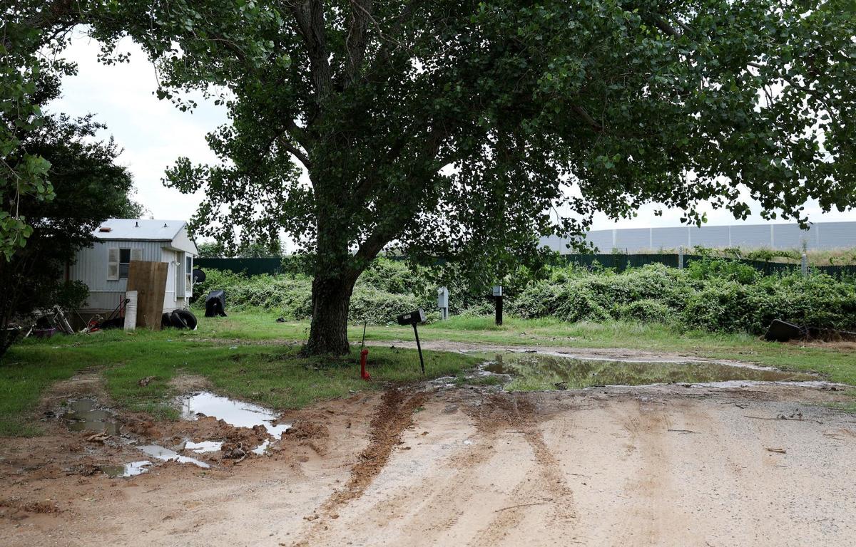 A 20-foot wall was built around a bitcoin mining facility operating in unincorporated Hood County to shield the neighboring mobile home park from noise, as seen on Wednesday, May 29, 2024.