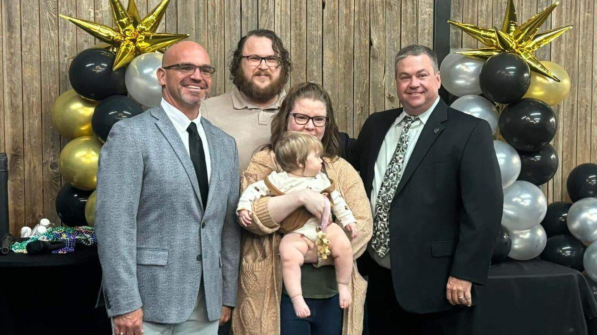The Gift of Adoption helps families with the financial challenges of adoption. Pictured are (from left) Scott Bruce, a member of the Texas board of directors; Fort Worth couple David and Jeanne Huitt with their adopted baby Krisalynn; and GOA Texas President Adam Pfeil.