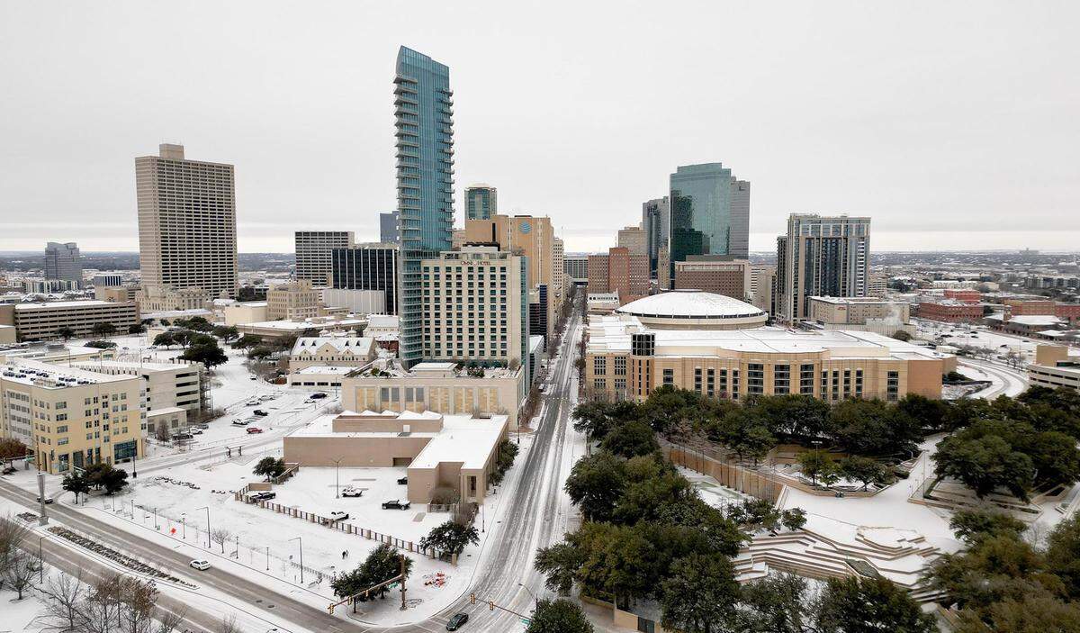 A thin layer of snow coats building and roads in downtown Fort Worth on Monday, January 15, 2024.