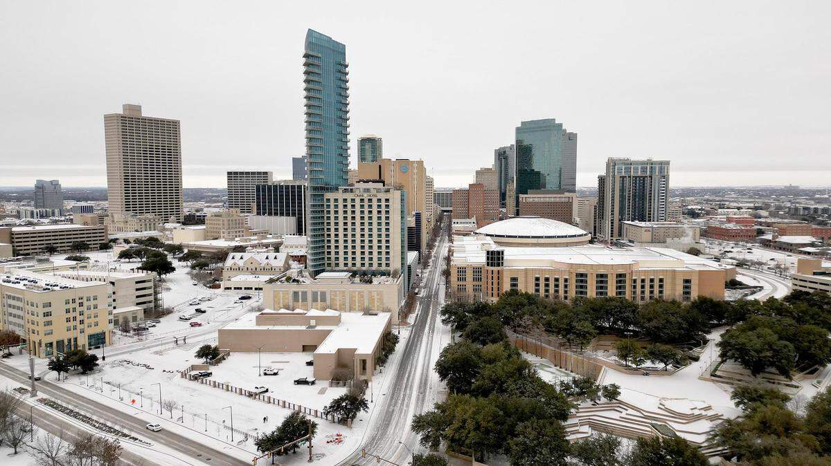 A thin layer of snow coats buildings and roads in downtown Fort Worth on Monday, January 15, 2024.