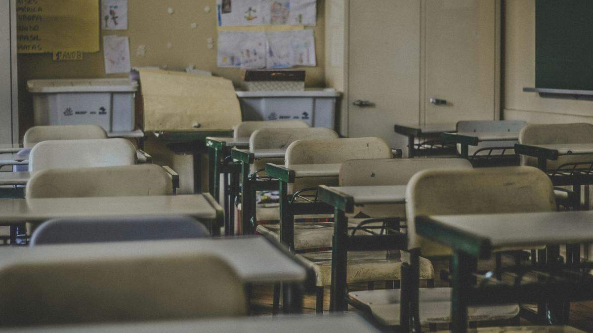 A Texas teacher was arrested at school and accused of making drug deals over the phone while in class, feds said. Nineteen others were indicted. 