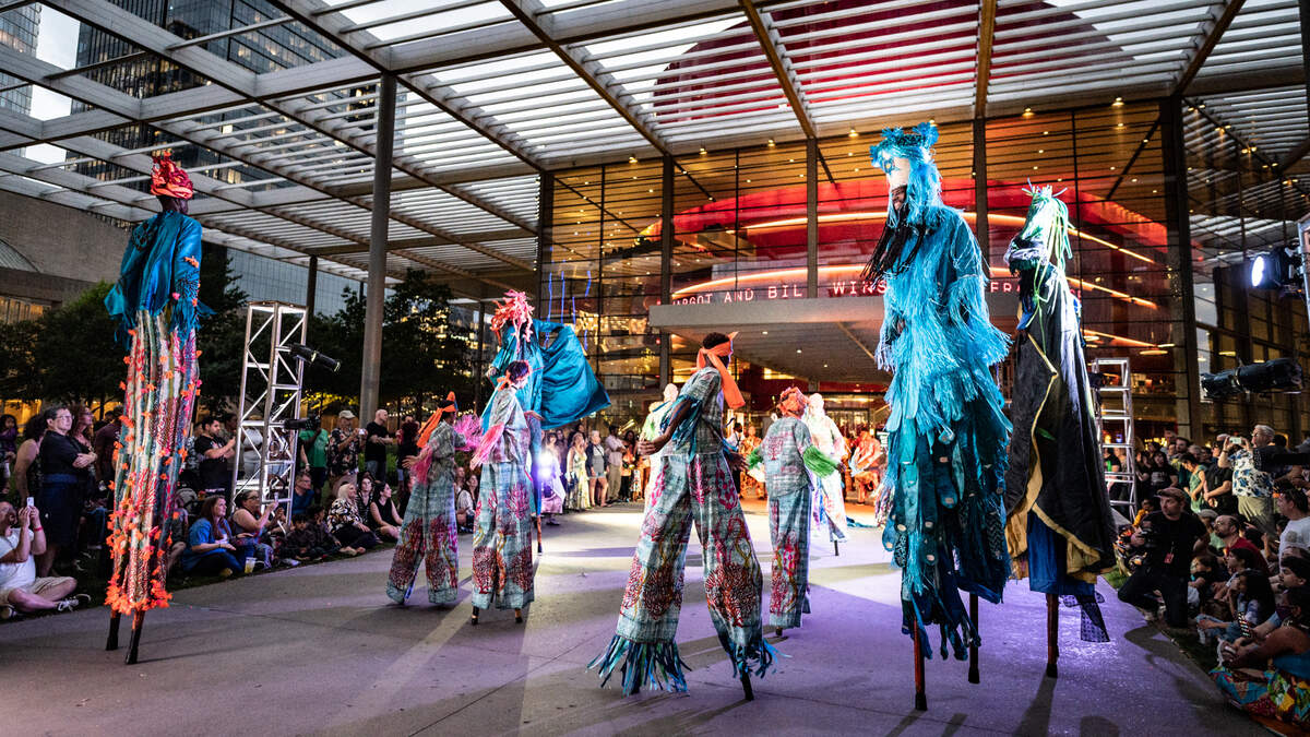 Members of the Amphibian Stage’s youth stilt dancing group the Tad-Poles join members of the Brooklyn Jumbies master stilt performers.