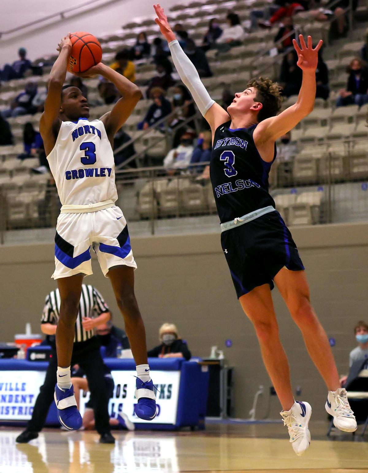 North Crowley guard Malik Clinton (3) attempts a shot over Byron Nelson guard Finley Bizjack (R) during the first half, Friday, February 26, 2021 of a 6A Region 1 Quarterfinal High School playoff Basketball game played at the Thomas Coliseum in Haltom City, Tx. (Steve Nurenberg Special to the Star-Telegram)