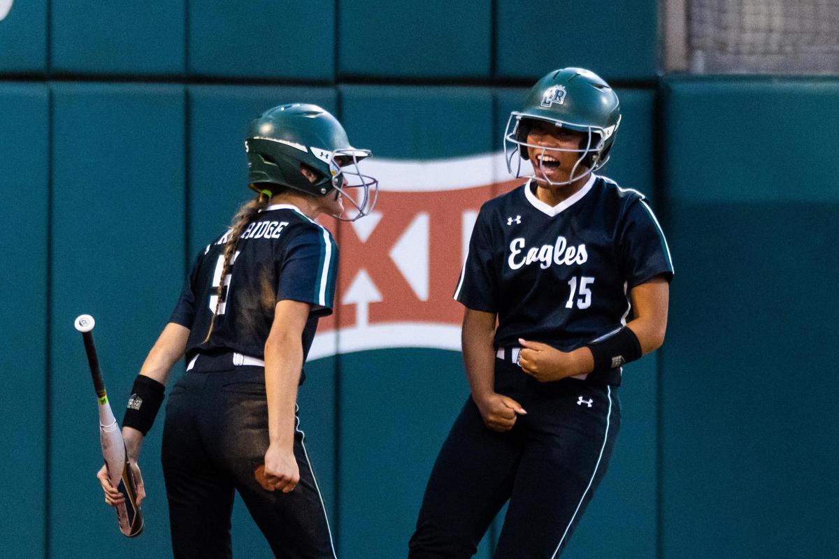 Madison Barnes (15) and Tia Warsop (5) celebrate a run during the 6A UIL State Softball semifinal between Lake ridge and Deer Park in Austin Texas, on June 3rd, 2021.