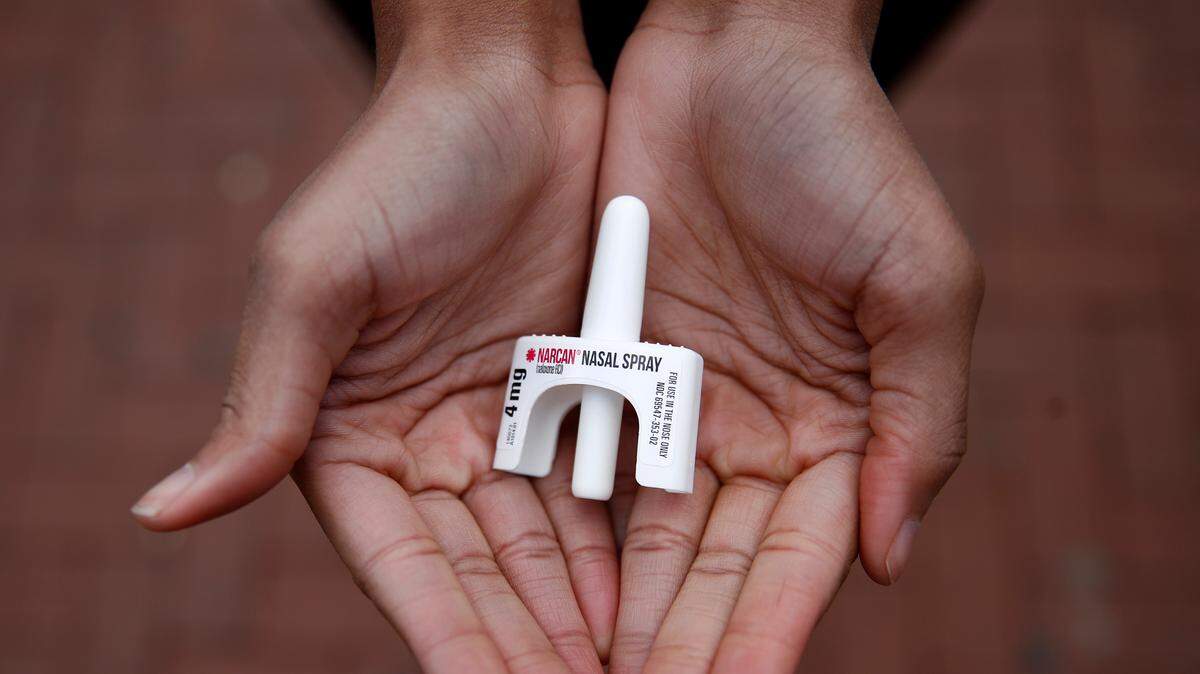 FILE - In this Jan. 23, 2018, file photo, Leah Hill, a behavioral health fellow with the Baltimore City Health Department, displays a sample of Narcan nasal spray in Baltimore. The overdose-reversal drug is a critical tool to easing America’s coast-to-coast opioid epidemic.