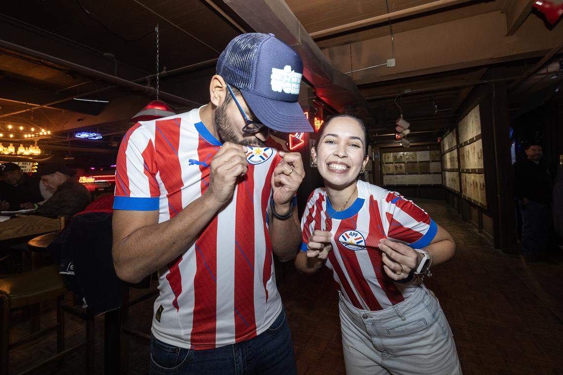 Fort Worth residents Javier Cabrera, left, and Damaris Gonzalez sport their Paraguay jerseys for the World Cup draw watch party Friday at Billy Bob’s Texas.