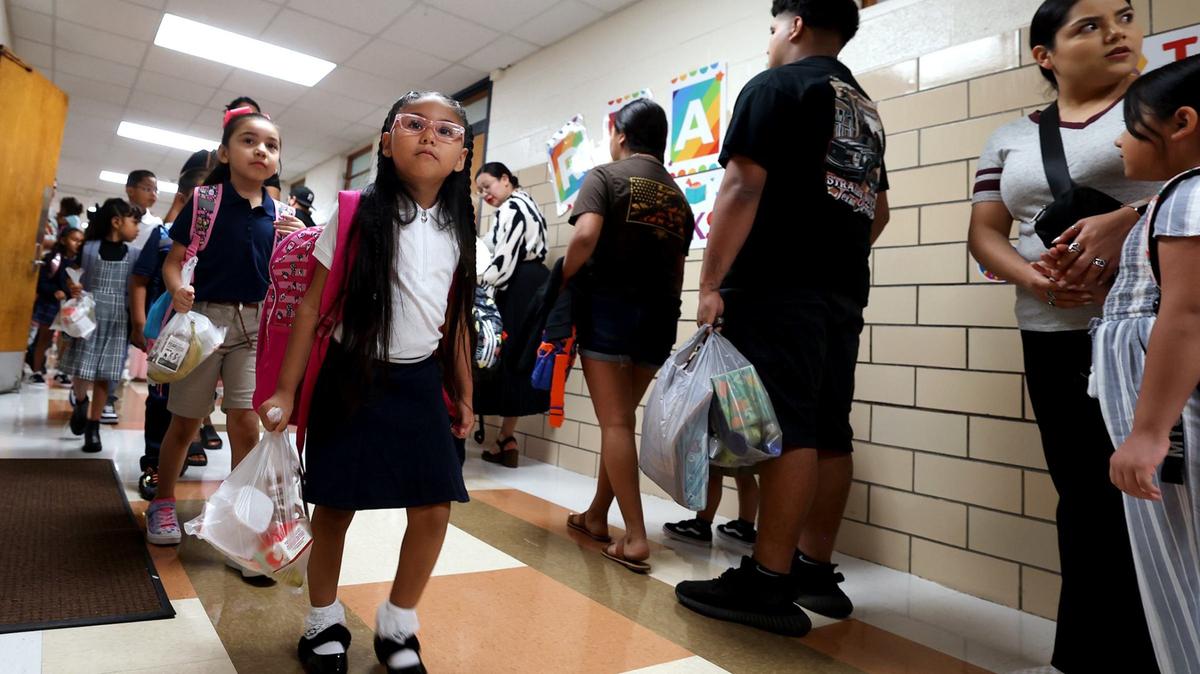 Students arrive at M.H. Moore Elementary School for the first day of school on Tuesday, Aug. 13, 2024.