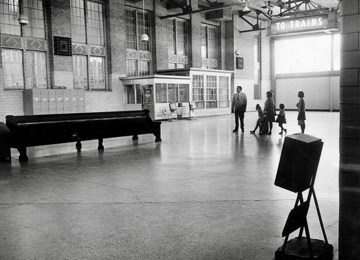 In the waning days of Texas & Pacific Railway travel, B.T. and Becky Balcom with their three daughters, Holly, Sally, and Linda, walk through the empty terminal on way to board a train May 31, 1969.