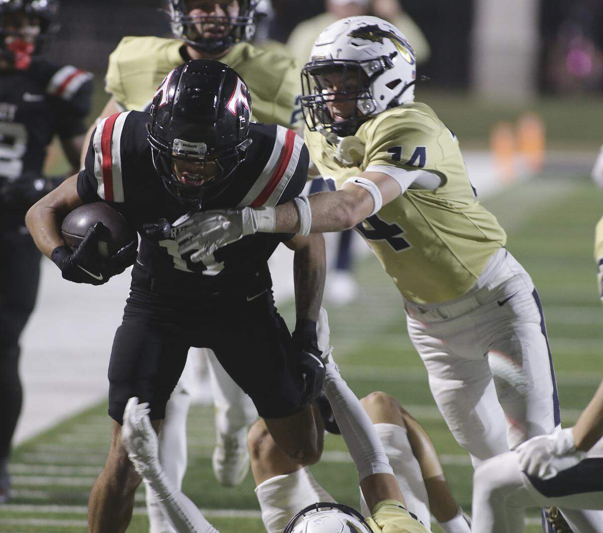 Euless Trinity’s Jaylon Donaldson (11) breaks tackles against Keller during their game on Friday, October 17, 2025 at Pennington Field in Bedford, Texas.
