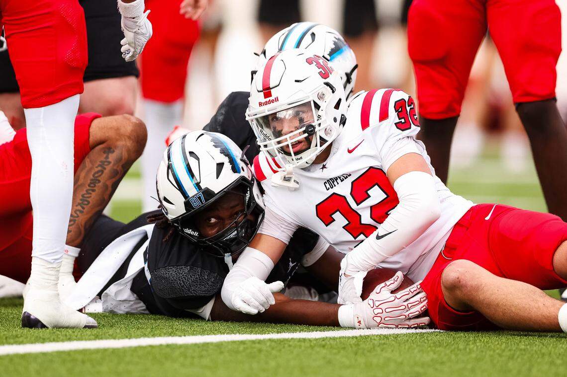 North Crowley running back Kiante Ingram (23) stretches the ball toward the goal line next to Coppell safety Anthony Lewis (32) while looking toward the official to make a call in a Class 6A Division I regional playoff Saturday, Nov. 29, 2025, at Midlothian ISD Stadium in Midlothian.