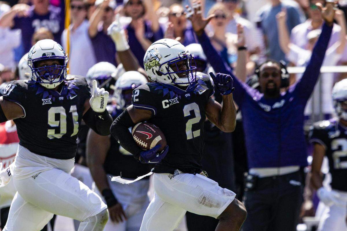 TCU cornerback Josh Newton (2) takes off down the sideline after an interception in the second half of a BIG 12 football game between the TCU Horned Frogs and the SMU Mustangs at Amon G. Carter Stadium in Fort Worth on Saturday, Sept. 23, 2023.