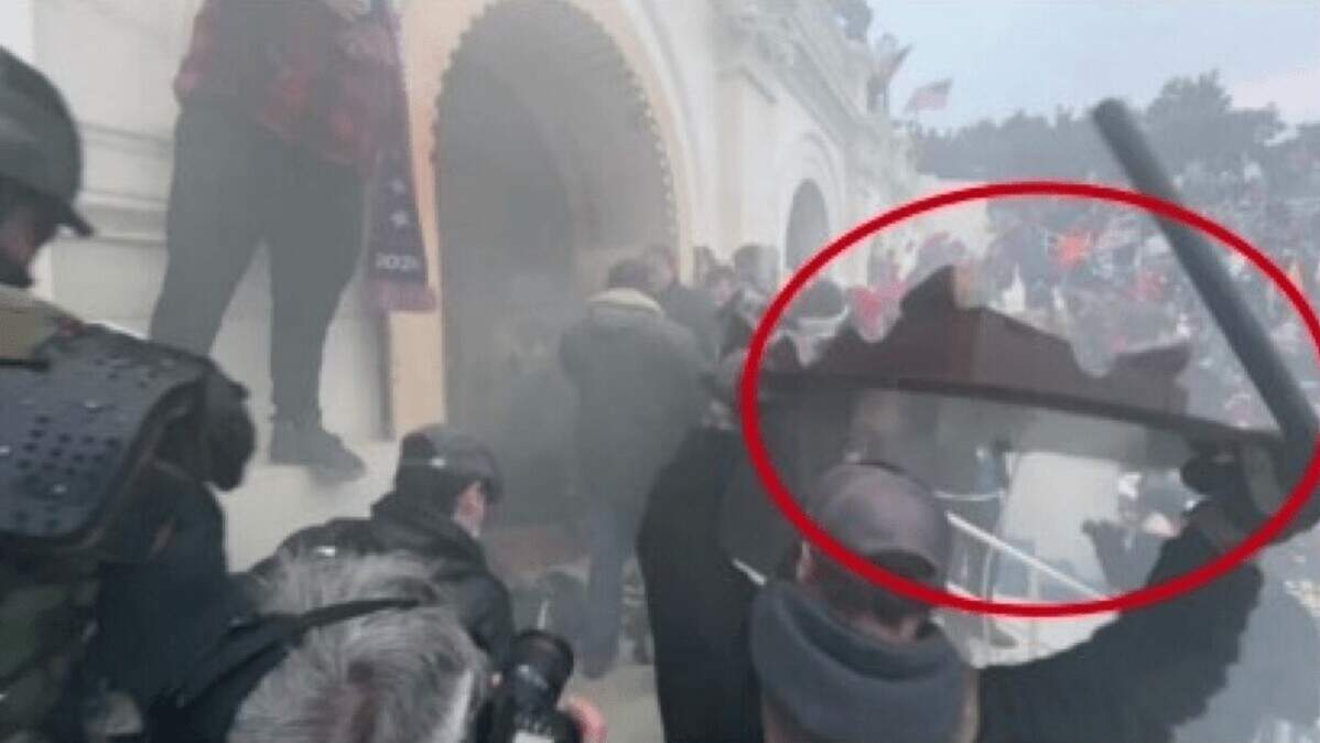 Thomas Ballard of Fort Worth, pictured in the red circle with a police baton and a table in his hands, was convicted of assaulting police officers during the Jan. 6 riot at the U.S. Capitol, according to federal authorities.