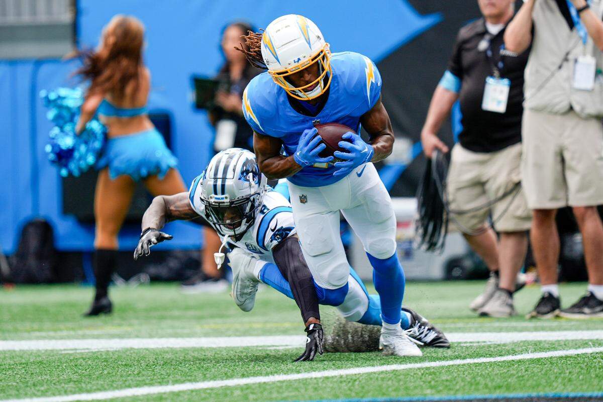 Los Angeles Chargers wide receiver Quentin Johnston (1) makes a touchdown catch defended by Carolina Panthers cornerback Jaycee Horn (8) the Carolina Panthers during the first quarter at Bank of America Stadium.