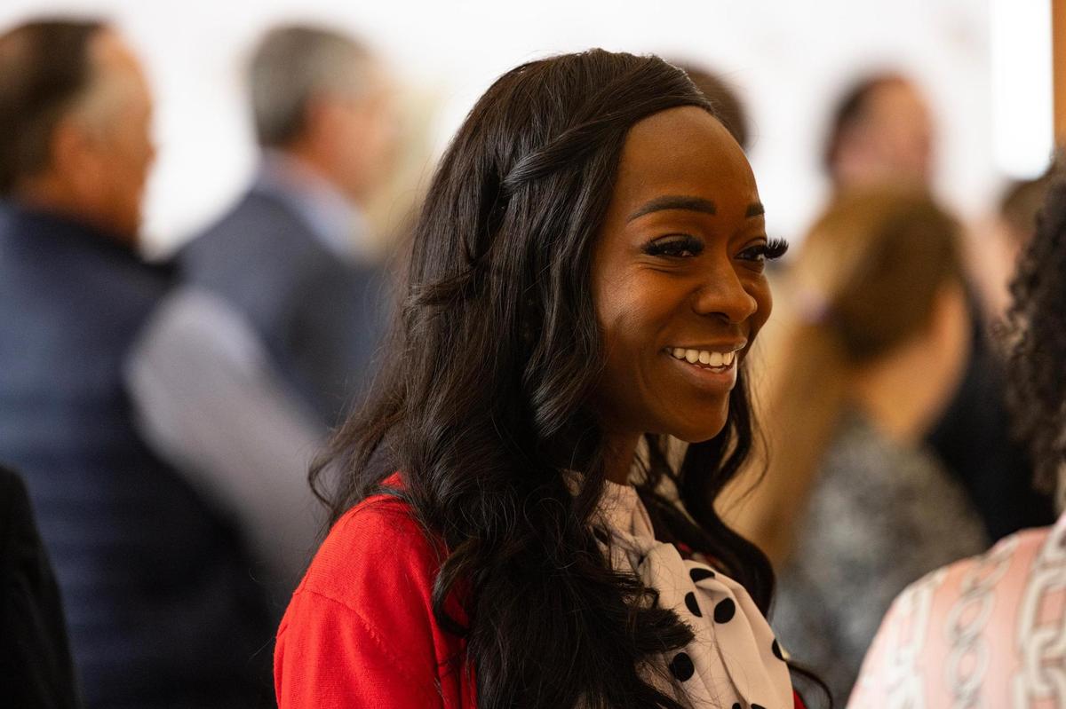 Mia Hall, a Crowley Independent School District board member and candidate for Fort Worth City Council, shares a laugh with guests gathered for the launch event of Fort Worth Students First at Ashton Depot in Fort Worth on Friday, April 4.