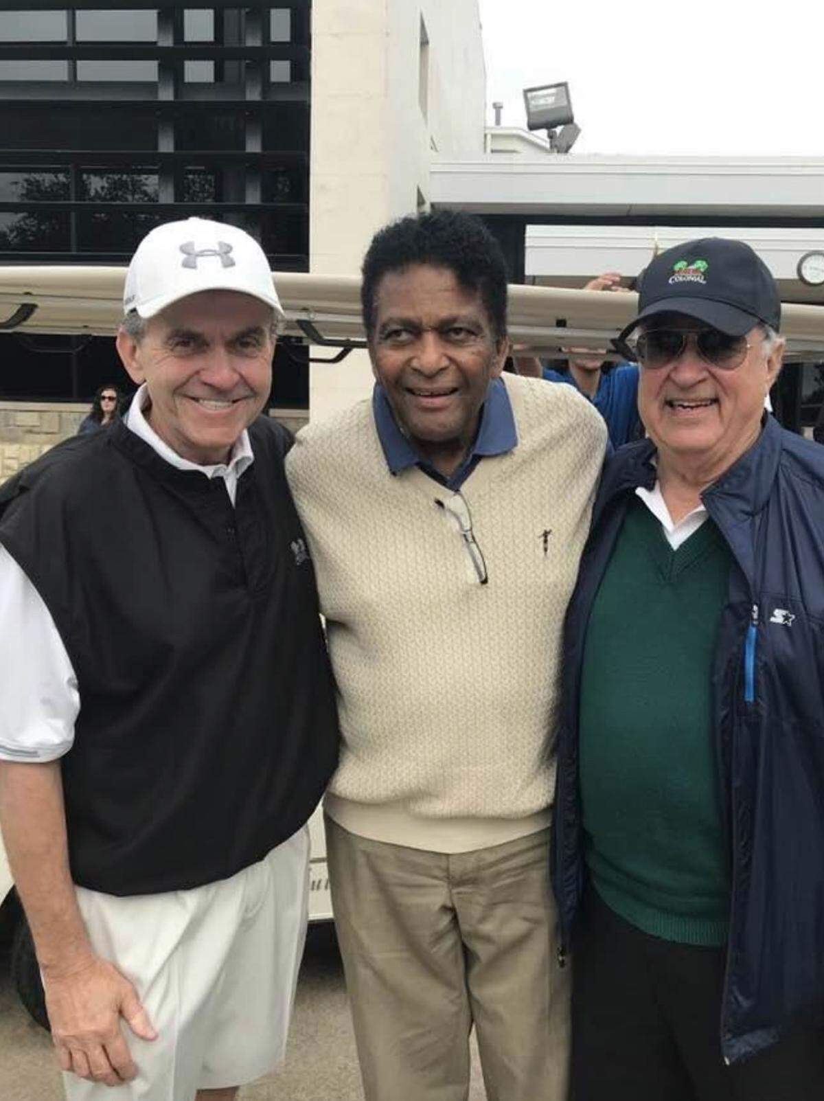 Len Roberts, former Radio Shack chief operating officer and longtime friend of Marvin Girouard and family, Charlie Pride, famous country musician, and Marvin Girouard, pictured at golf course. 