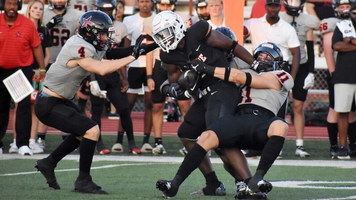 Arlington Bowie receiver Zion Shelley is wrapped up by Coppell linebacker Weston Polk (11) during a UIL football game at Wilemon Field in Arlington on Friday, Sept. 19, 2024.