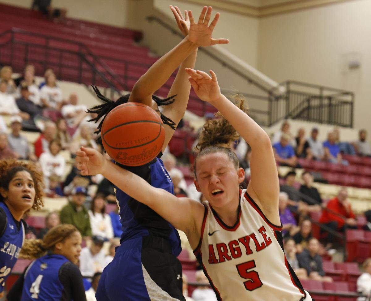 Mansfield Summit guard Kyndal Hardaway (3) fouls Argyle guard Wrigley Green (5) on the way to a bucket during the first half of a UIL Class 5A DII girls playoff basketball game at Saginaw High School in Saginaw, Texas, Thursday Feb. 19, 2026.