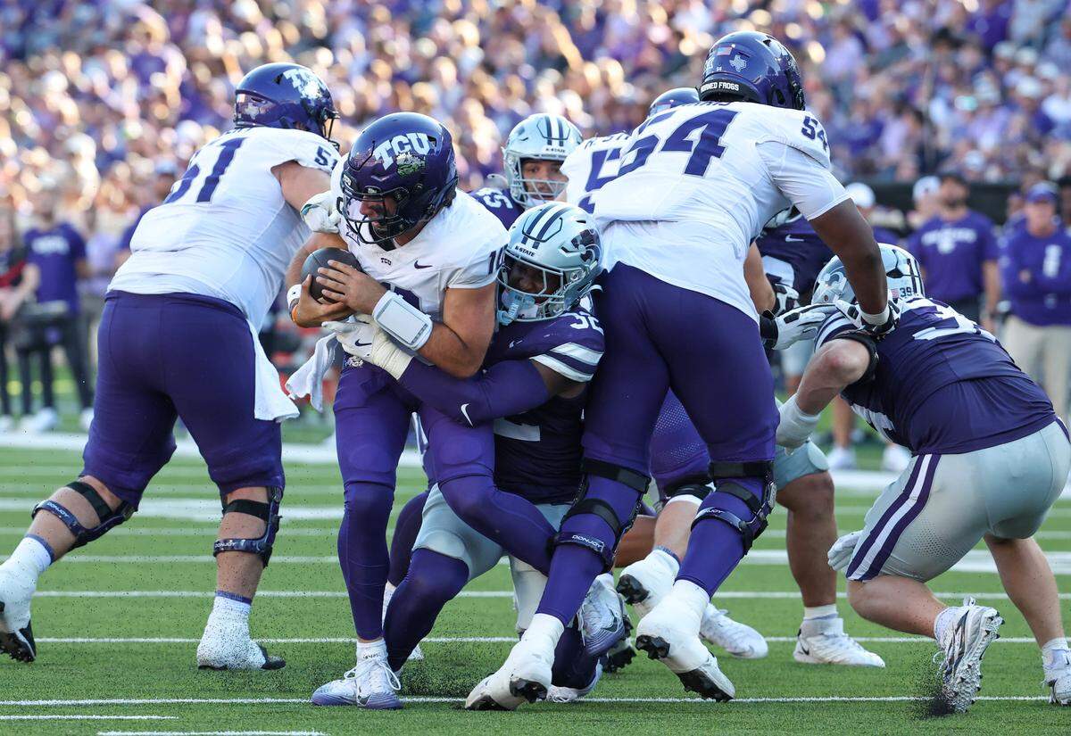 Oct 11, 2025; Manhattan, Kansas, USA; TCU Horned Frogs quarterback Josh Hoover (10) is sacked by Kansas State Wildcats linebacker Desmond Purnell (32) during the third quarter at Bill Snyder Family Football Stadium. Mandatory Credit: Scott Sewell-Imagn Images