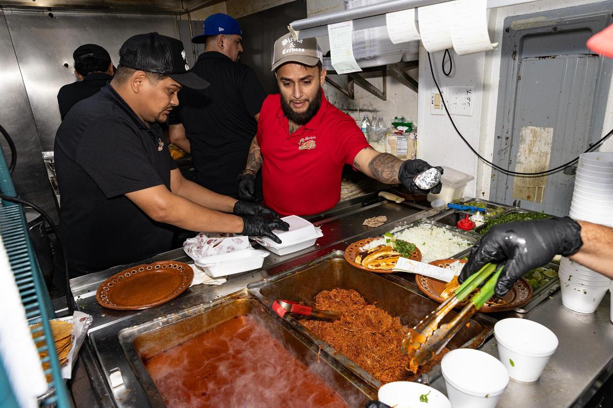 Ruben, left, and Diego Cortez, left, prepares food orders on the line at Birrieria y Taqueria Cortez in Fort Worth on Wednesday, Nov. 20, 2024. The restaurant earned a Michelin Recommended rating, landing the taqueria on a prestigious list of eateries around the nation.