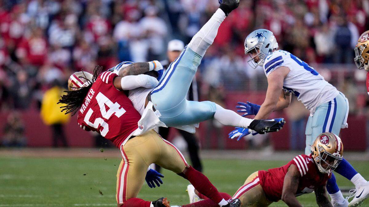 San Francisco 49ers linebacker Fred Warner (54) tackles Dallas Cowboys running back Ezekiel Elliott during the first half of an NFL divisional round playoff football game in Santa Clara, Calif., Sunday, Jan. 22, 2023. (AP Photo/Godofredo A. Vásquez)