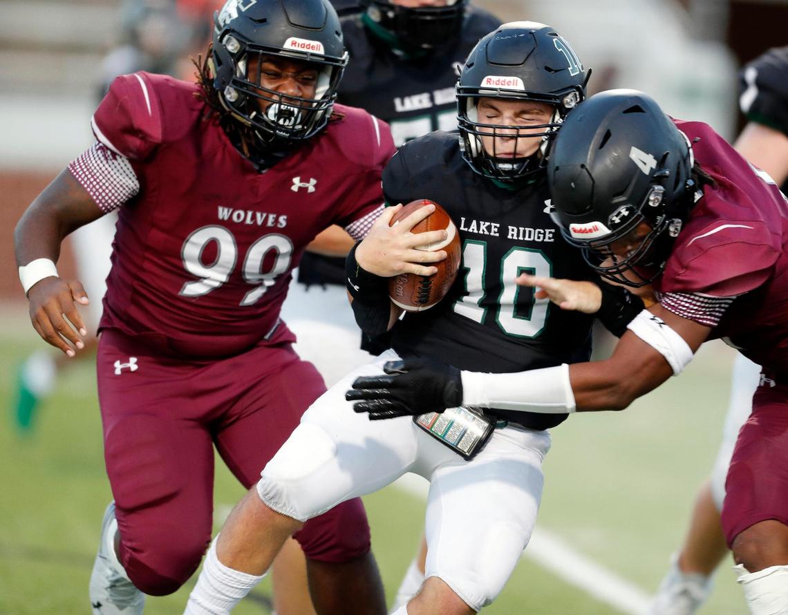 Timberview’s defense consisting of (99) and defensive end Terrell Tilmon (4) bring down Lake Ridge quarterback Trevor Andrews (10) in the backfield during a high school football game at Vernon Newsom Stadium in Mansfield, Texas, Thursday, Sept. 24, 2020. Timberview defeated Lake Ridge 28-14 in their first game of the season. (Special to the Star-Telegram Bob Booth)